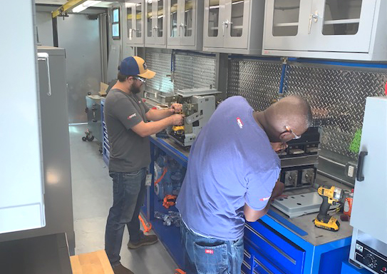 technicians work in mobile breaker shop