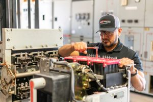 shop technician repairs circuit breaker